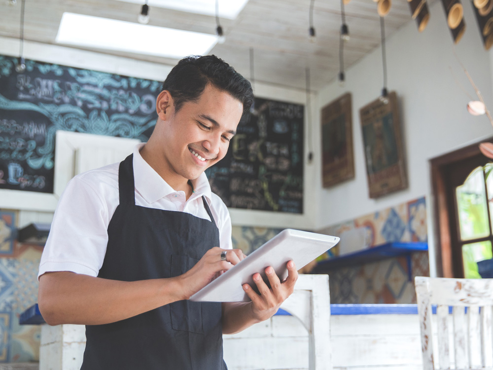 Small business owner looking at tablet
